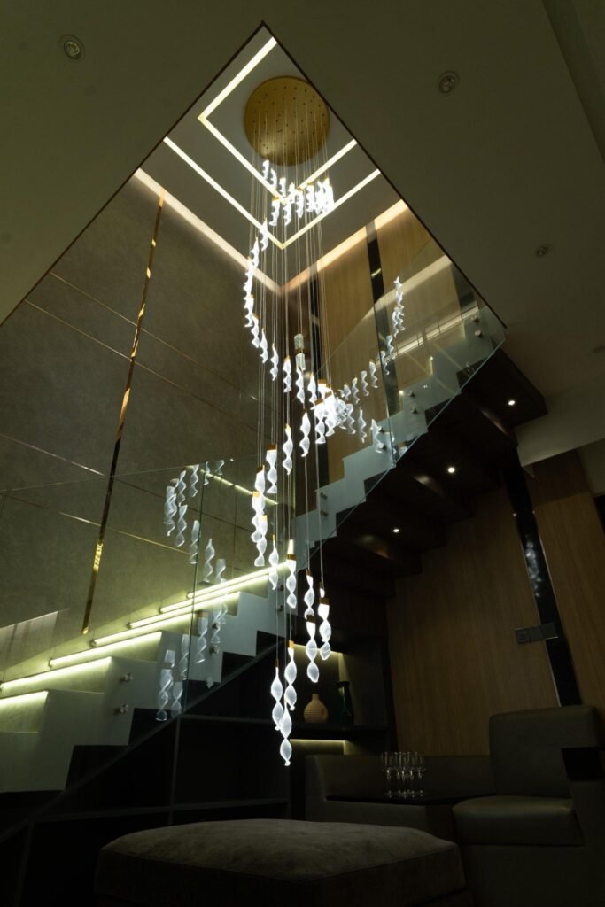 Luxury staircase chandelier design inside modern resort